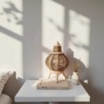 Round lemon wood lighting 9" table lamp with natural straw weave displaying warm ambient glow on white surface