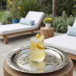 Silver hammered decorative tray with lemonade drink on outdoor patio table