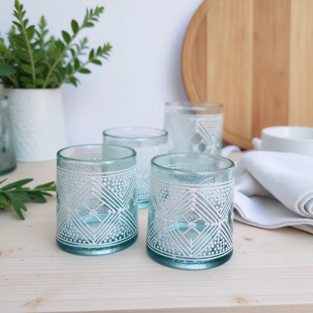 Set of authentic Moroccan beldi glasses with geometric designs on light counter
