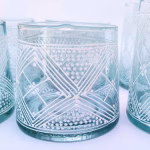 Set of authentic Moroccan beldi glasses with geometric designs on light counter