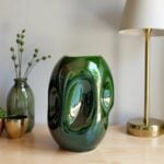 Handcrafted green ceramic vase with abstract sculptural indentations and glossy glaze finish