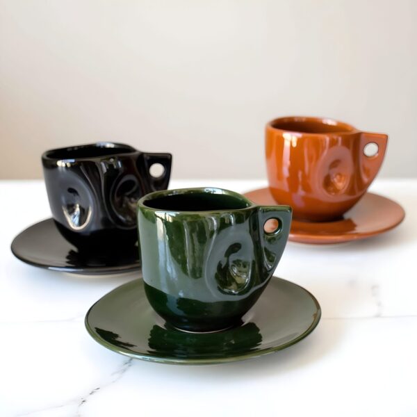 Handmade Moroccan ceramic coffee cups set in black, green, and terracotta with matching saucers and swirl design