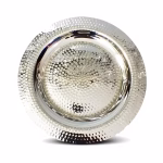 Close-up of handmade hammered silver decorative tray showing intricate texture pattern