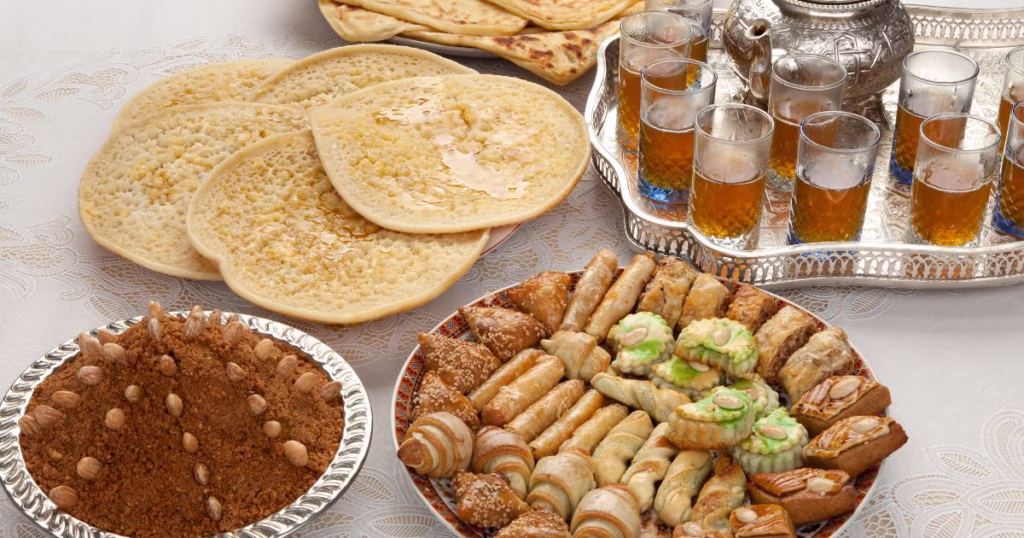 Moroccan tea with Moroccan treats like Msemen Baghrir and Almond sweets