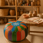 Multicolored leather floor ottoman pouf in artisan craft studio with pottery and natural wood shelving
