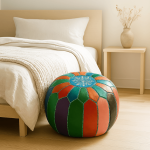 Round leather floor ottoman with vibrant patchwork design and decorative snowflake center by bedroom