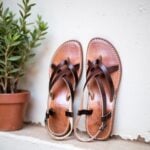 Artisan-crafted Moroccan leather sandals with interwoven brown straps on tan footbed, handmade details