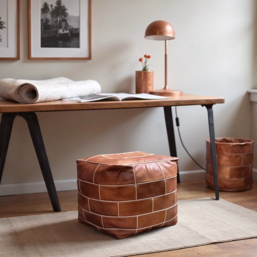 Square leather pouf ottoman next to modern desk setup
