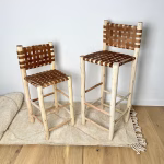 Handwoven-leather-bar-stools-in-tan-cowhide-with-natural-wood-frame-shown-in-two-heights