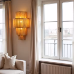 Tiered raffia wall sconce creating cozy atmosphere in living room with large windows