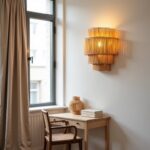 Boho handwoven raffia wall sconce with layered design above white desk creating warm filtered lighting effect