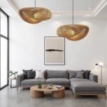 Two handwoven rattan pendant lamps with wave design illuminating contemporary gray sectional living room