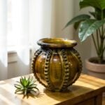Stylish ceramic vase 30cm with raised patterns in warm amber glaze displayed on wooden table with succulent
