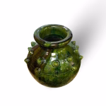 Traditional Moroccan Tamegroute pottery vase with characteristic green glaze and decorative elements, top view
