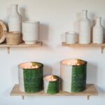 Artisanal ceramic candle set featuring green and white multi-wick holders on rustic wooden shelf