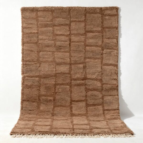 Handwoven Moroccan wool rug with textured grid pattern in natural brown tones and fringe detail