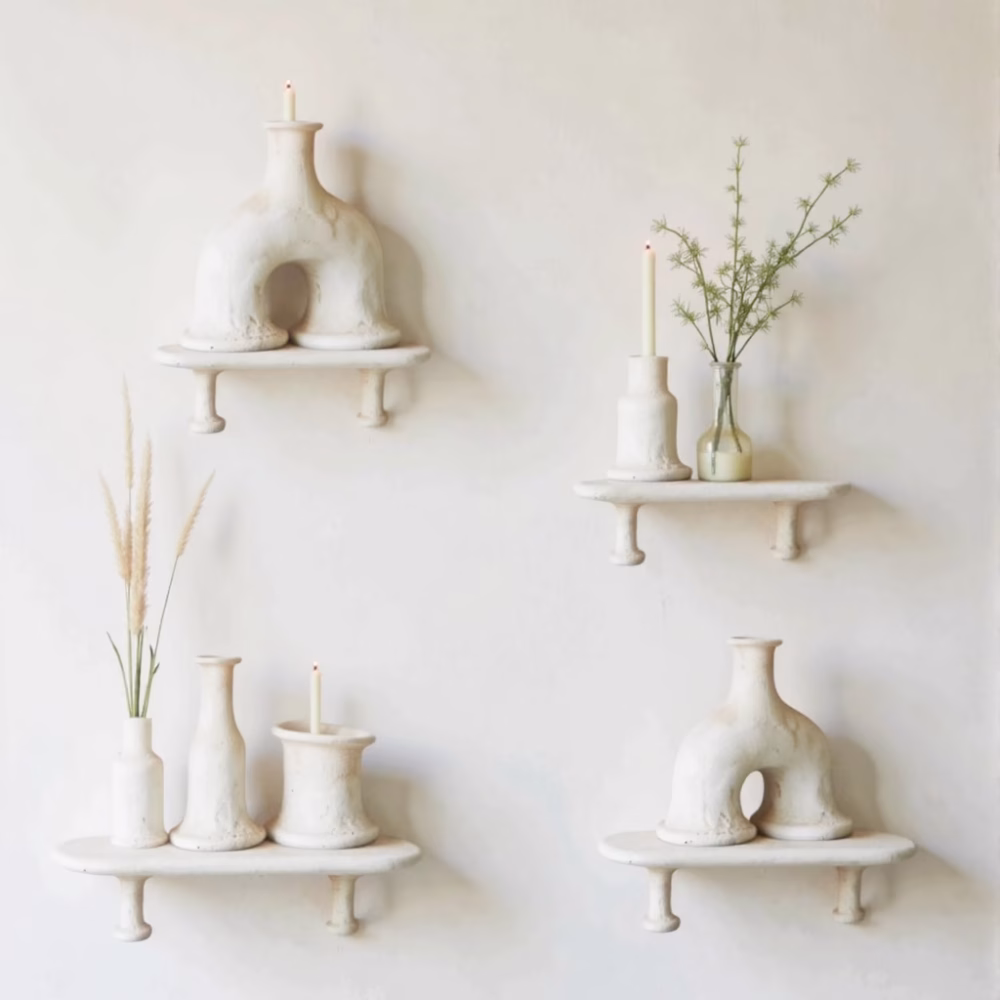 Collection of white Moroccan arch candleholders on floating shelves