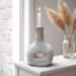 Gray tamegroute pottery candle holder bottle styled with dried pampas grass