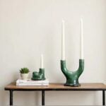 Tamegroute green ceramic candle holder set displaying sculptural twin arc design on wooden shelf