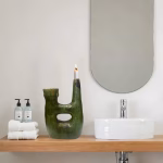 Green Tamegroute pottery candle holder in modern bathroom setting