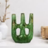 Green ceramic candle stick holder with geometric arch design