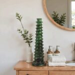 Forest green ceramic candle holder with stacked ring design on modern kitchen counter
