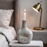 Handcrafted gray candleholder styled in bedroom setting