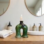 Tamegroute green ceramic candle holder with sculptural arch form displayed in modern bathroom setting