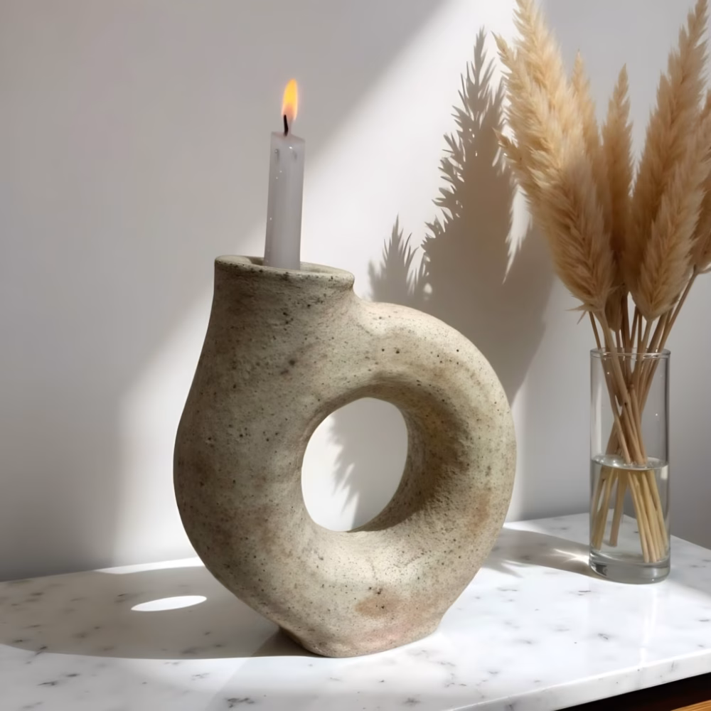 Handcrafted white ceramic candle holder with ring design in natural light