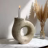 Handcrafted white ceramic candle holder with ring design in natural light