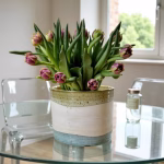 Indoor ceramic planter on glass table with fresh flowers