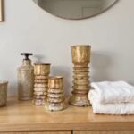 Tamegroute ceramic candleholders set of 3 in weathered green finish on wooden bathroom vanity with towels