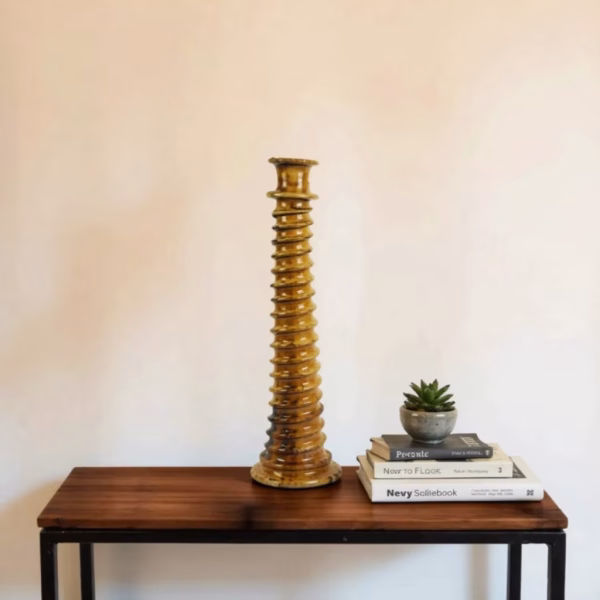 Light brown tall candle holder on side table