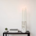 Modern ceramic triple candle holder on black table