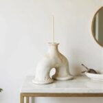Architectural white ceramic candleholder with signature arch cutout, handmade statement pottery piece closeup