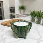 Handmade ceramic candle 10 inch bowl in emerald green on marble kitchen countertop