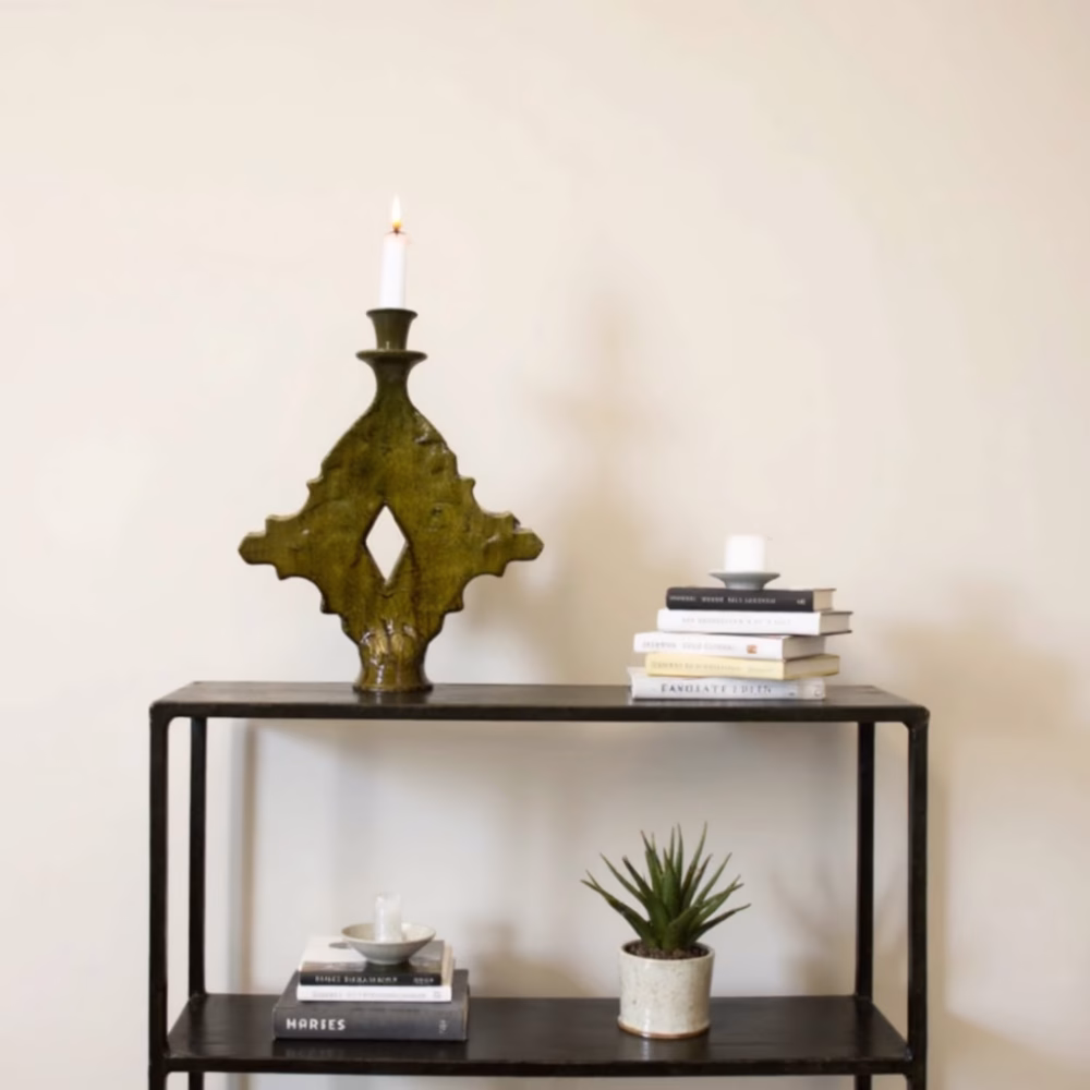 Moroccan ceramic ochre candle holder on black metal console