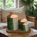 Handcrafted ceramic candle set with Tamegroute green glaze on woven tray near natural fiber pillows