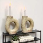 Pair of sculptural ceramic candle holders with ring design on black shelf, handmade Tamegroute pottery, modern home decor