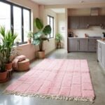 Millennial pink Moroccan wool rug with textured grid in open kitchen featuring gray cabinets