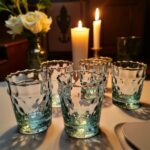Aqua handblown diamond tea glasses illuminated by candlelight highlighting the textured recycled glass bubbles