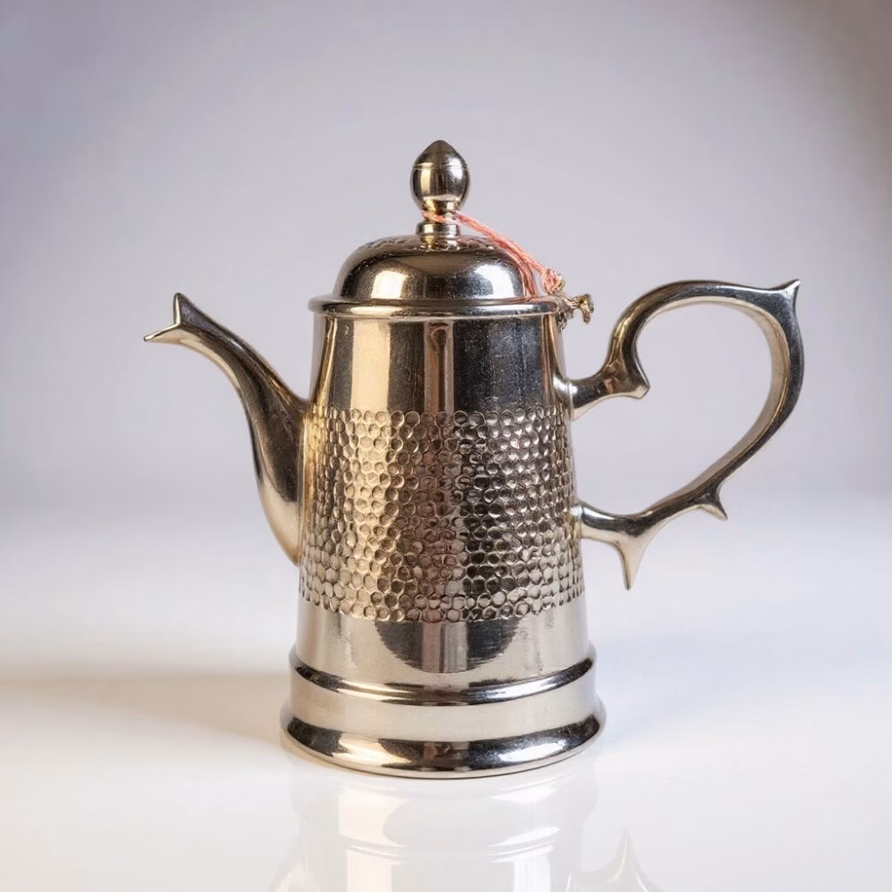 Silver-plated brass Moroccan coffee pot on display stand