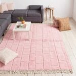 Blush pink shag Moroccan wool rug with geometric blocks in contemporary living room with gray sofa