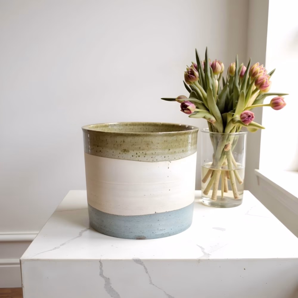 Tricolor planters ceramic indoor with pink tulips on white surface