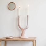Natural white ceramic candle holder with pink marble glaze twin arc design on wooden table
