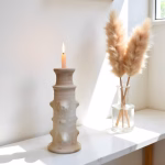 White Moroccan pottery candlestick with pampas grass decor