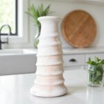 White spiral ceramic candle holder tower, handcrafted Tamegroute pottery on kitchen counter with plants