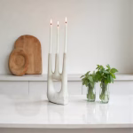 White ceramic triple candle holder with fresh herbs