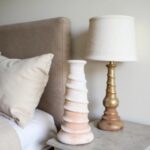Artisan ceramic candle holder, white spiral tower 35cm tall on nightstand beside bedroom lamp