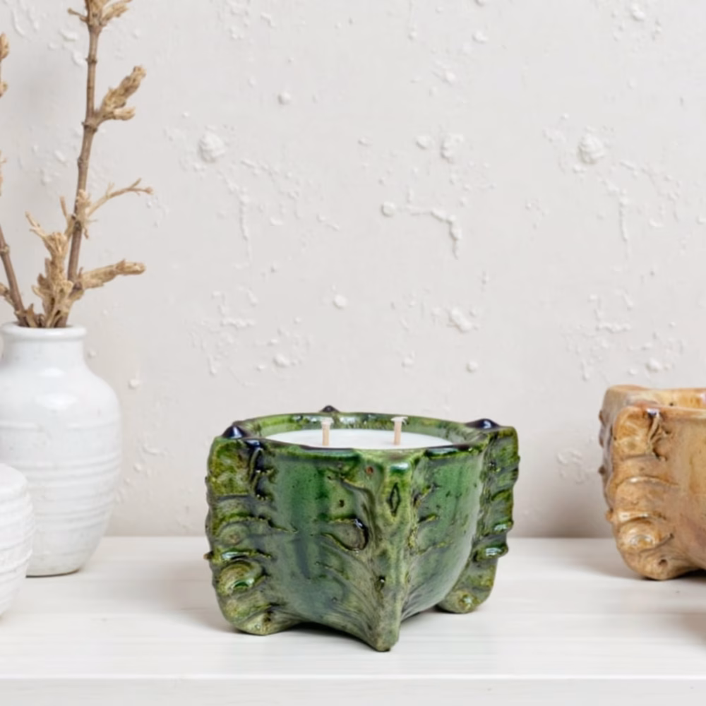 candle in ceramic Green bowl with leaf pattern on white surface